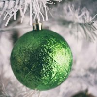 green bauble on a white tree.