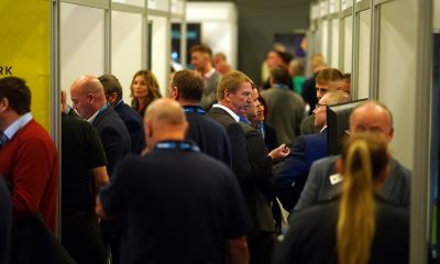 A group of people standing in front of a crowd at EMCON